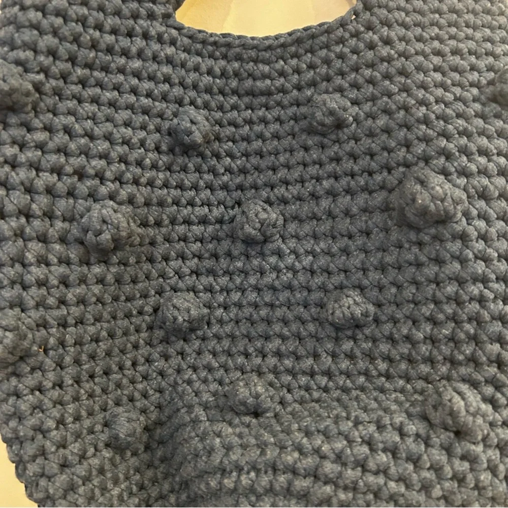 Hand-crocheted blue tote bag with bobble stitch details.